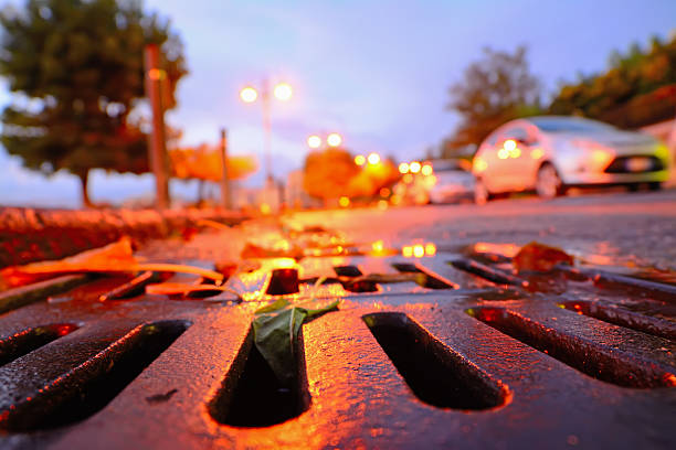 drainage sewer at sunset close up of a drainage sewer at sunset drainage photos stock pictures, royalty-free photos & images