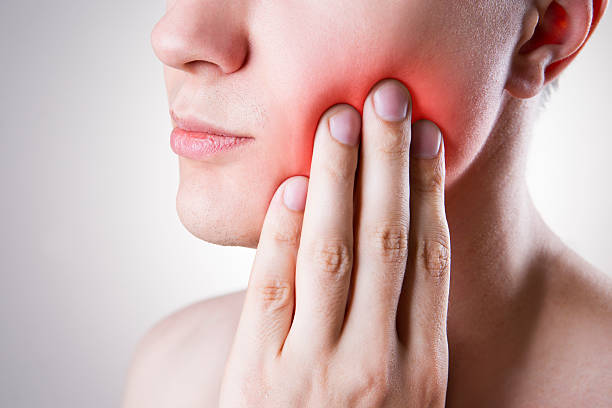 Man with a toothache. Pain in the human body stock photo