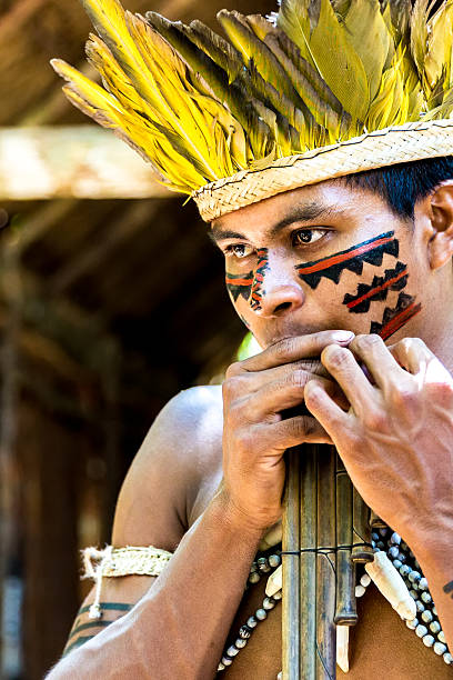 istock Native Brazilian playing wooden flute 495600086