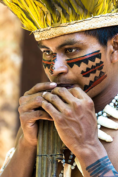istock Native Brazilian playing wooden flute 495600692