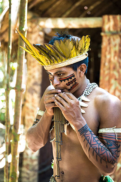 istock Native Brazilian playing wooden flute 495600804