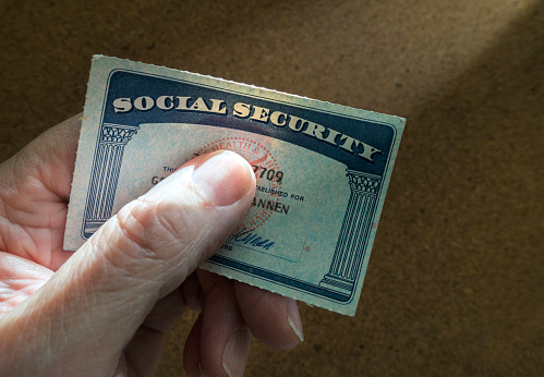 man holding social security card