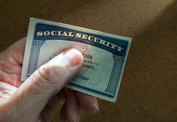 social security card man holding social security card identity theft photos stock pictures, royalty-free photos & images
