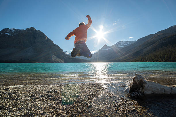 istock Cheerful young man jumping high up in the air 495601784