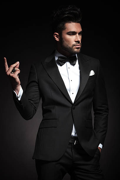 istock elegant business man in tuxedo snapping fingers 495602454