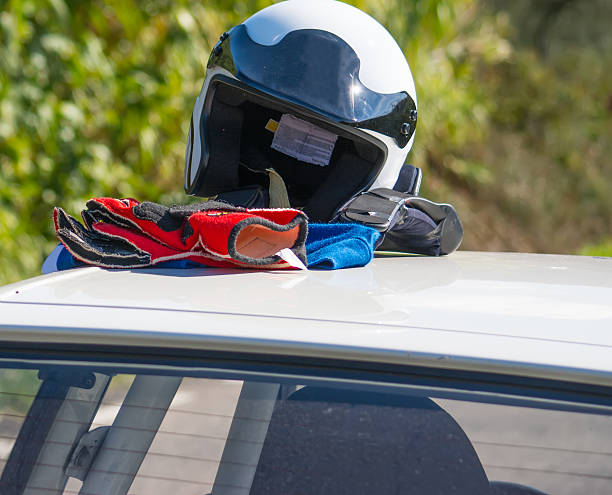 istock helmet and gloves on a car rooftop 495602780