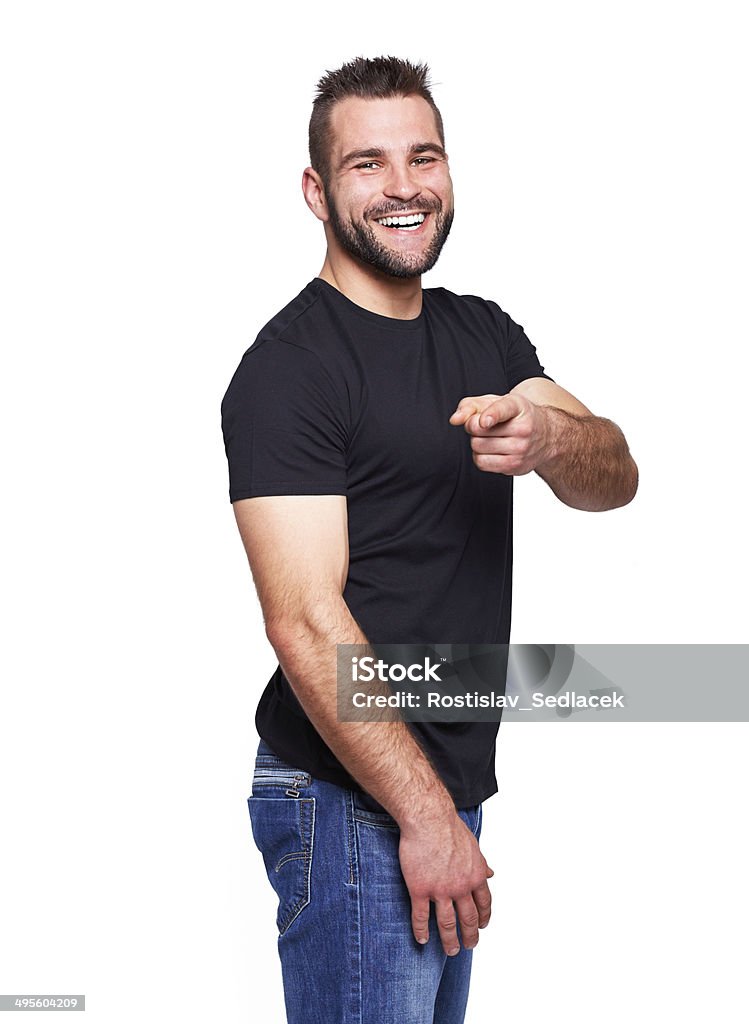 Young happy man in a black T-shirt Young happy man in a black T-shirt with finger towards camera Adult Stock Photo