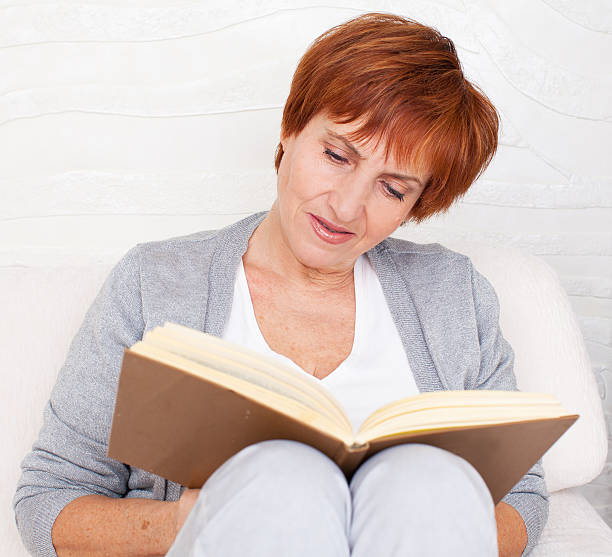 istock Adult woman reading book 495604371