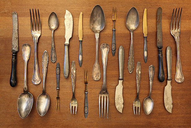 istock Vintage silverware collection on a wooden table, kitchen background 495604980