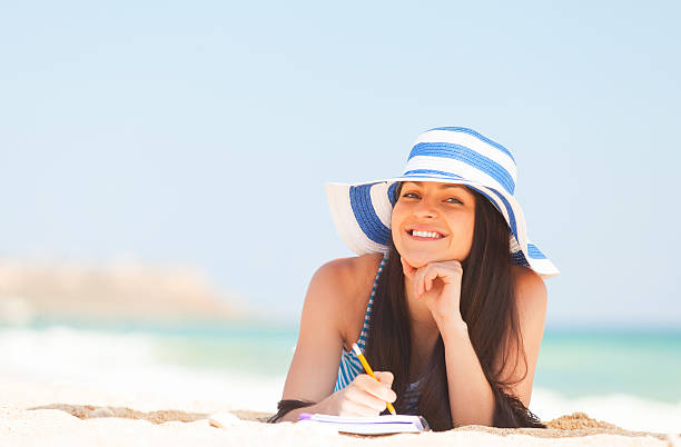 istock Young brunette girl with note and pencil 495605381