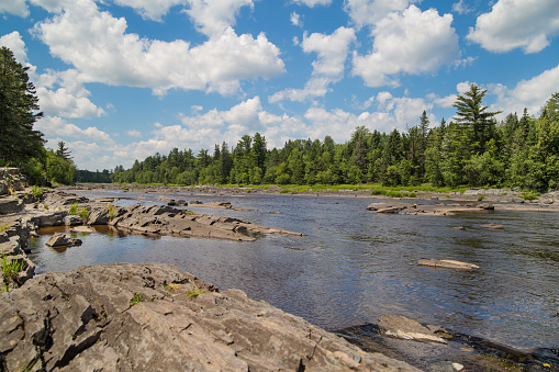 Jagged rocks protrude from the flowing St. Louis River as it winds through Jay Cooke State Park in Minnesota