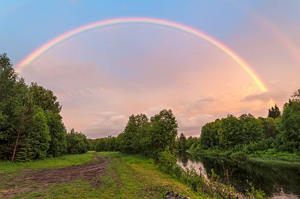 istock Beautiful double rainbow over river with dirty road along 495605979