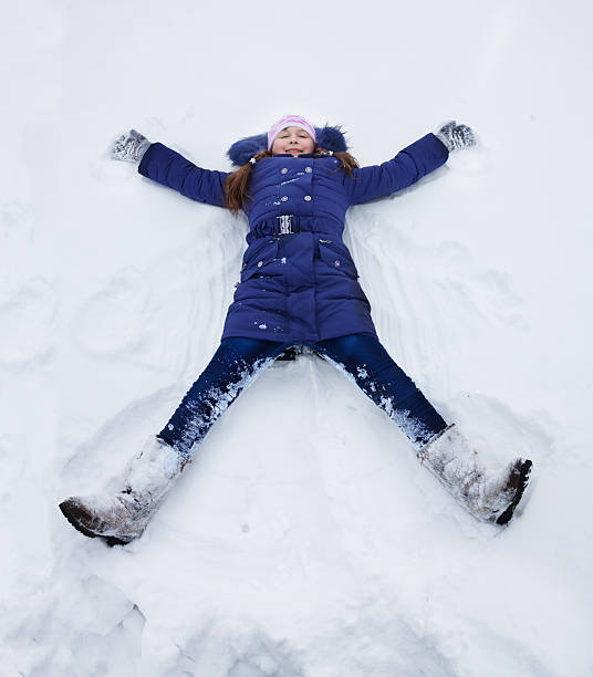 istock Girls laying star shape in snow 495606235
