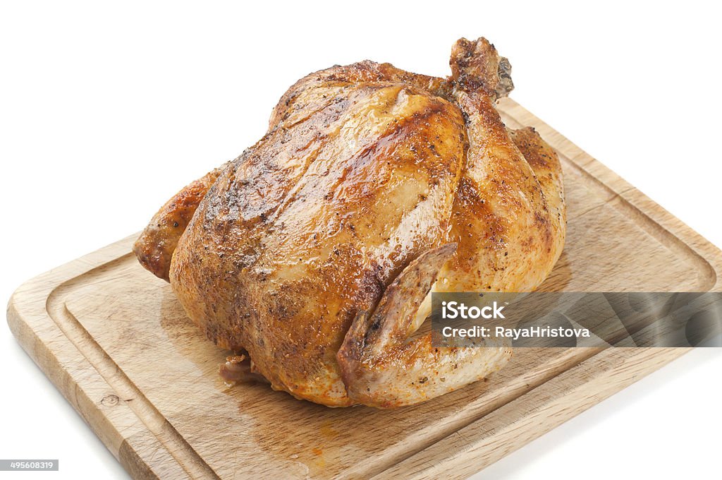roasted chicken Whole roasted chicken on wooden board Brown Stock Photo