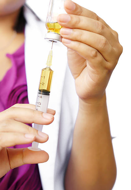 istock Doctor with syringe in hands, getting ready for injection 495609579