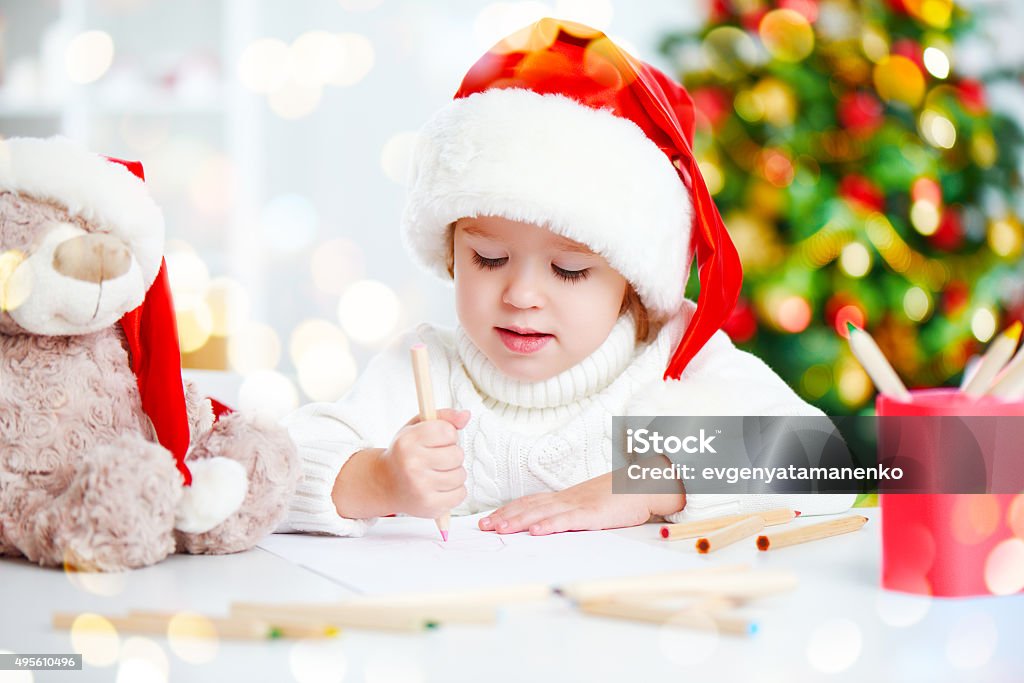 child before Christmas writes a letter to Santa child girl before Christmas writes a letter to Santa Claus 2015 Stock Photo