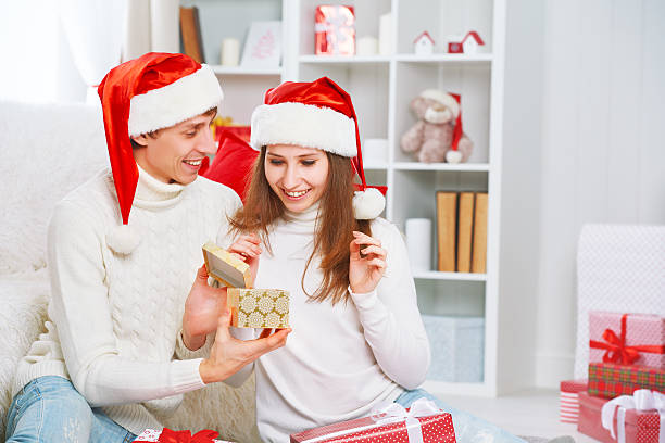 istock Christmas gift. man gives a woman gift present box 495611330