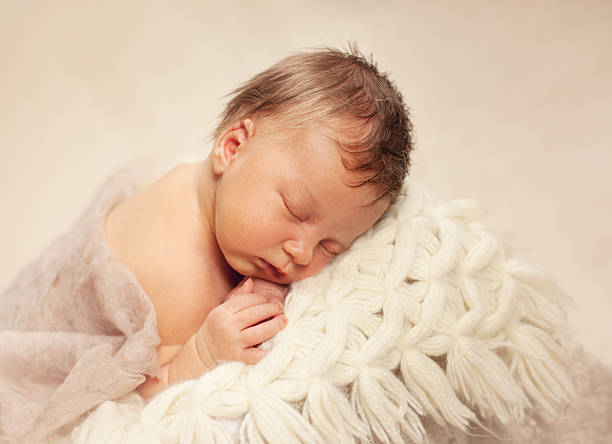 istock healthy newborn baby sleeping 495612110