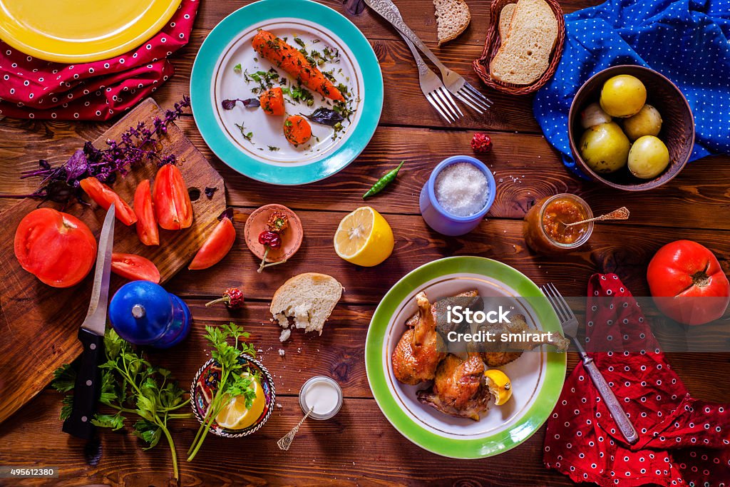 Table setting Top view of a Table setting with a variety of side dishes on a wooden table Crockery Stock Photo