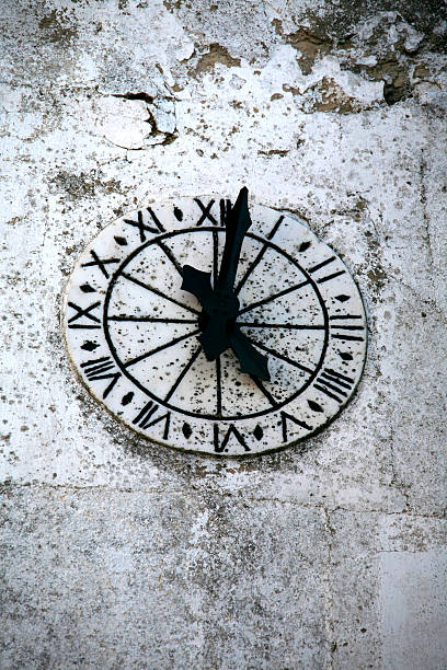 istock clock of the church in stone 495613128