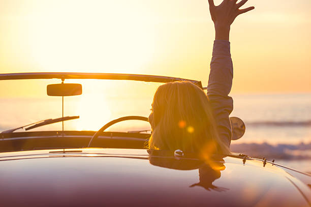 istock Woman watching the sunset in a convertible car. 495613954