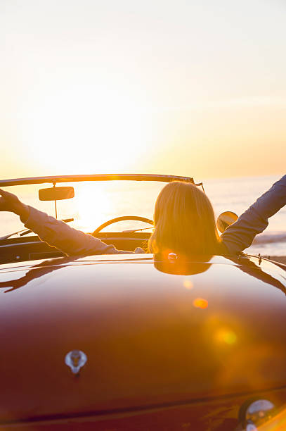istock Woman watching the sunset in a convertible car. 495614094