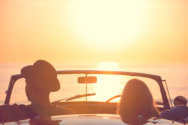 istock Couple watching the sunset in a convertible car. 495614216
