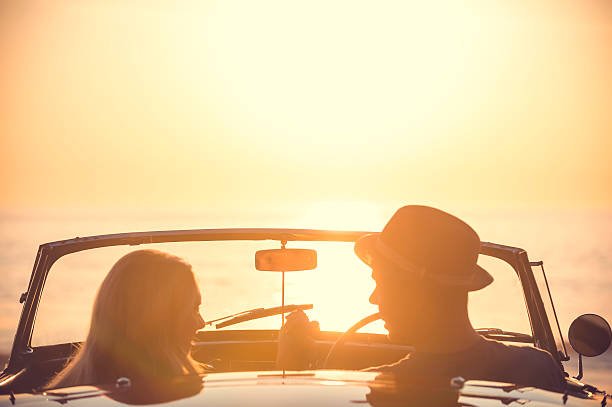 istock Couple watching the sunset in a convertible car. 495614346