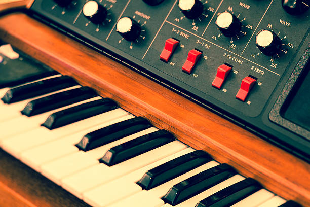 Abstract toned image of vintage synthesizer keyboard musical instrument. Selective focus and tilt.