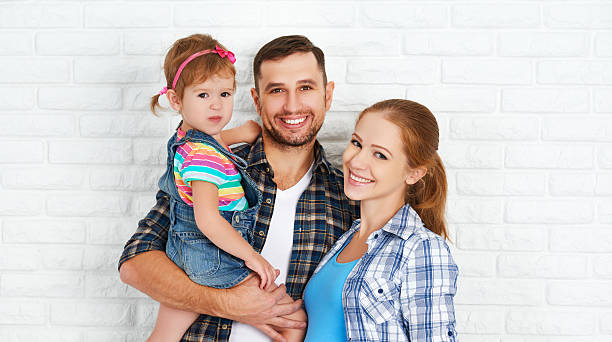 istock happy family home on brick wall background 495615634
