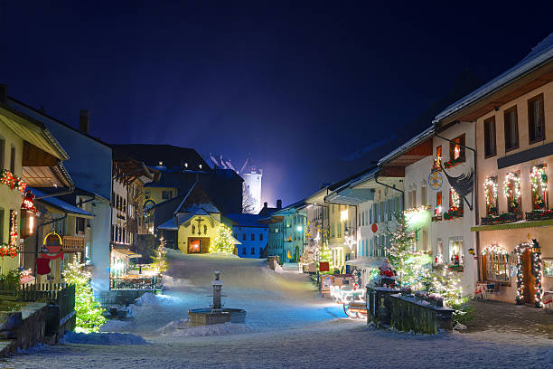 Winter night in the medieval town of Gruyeres Winter night in the medieval town of Gruyeres, district of Gruyere, Fribourg canton, Switzerland fribourg city switzerland stock pictures, royalty-free photos & images