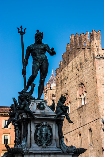 The 1563 Fountain of Neptune in front of the grand buildings of Piazza del Nettuno, Bologna, Italy.