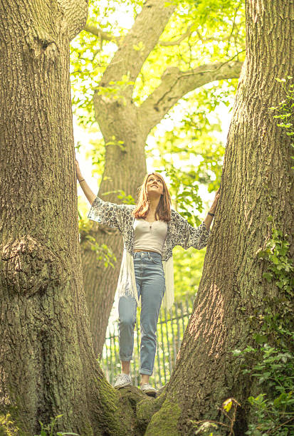 istock Girl standing in trees 495621498