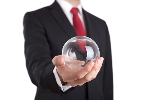 Businessman holding a glass ball isolated on white. Clipping path included. 