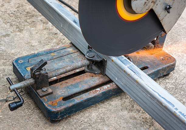 istock Cutting a square metal and steel with compound mitre saw 495622984