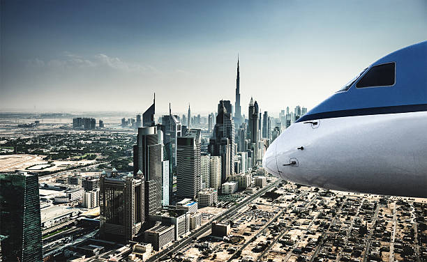 istock commercial airplane flying over the dubai downtown 495624090