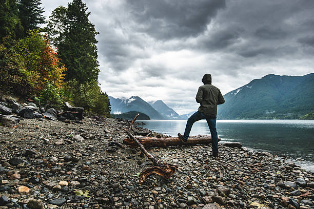 istock Solitude man pensive on the lake side 495625114