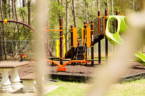 istock View through fence of empty park or school playground. 495625159