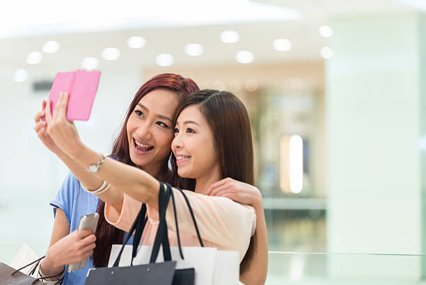 istock Asian Girlfriends Posing for a Selfie in a Shopping Mall 495625333