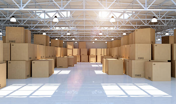 Large modern warehouse full of mechandise and cardboard boxes Indoor view of a new warehouse building full of retail items and merchandise cardboard boxes. Plenty of goods are packed, arranged and stacked in the big storage room. Large industrial space with steel and concrete structure for storage, freight distribution and shipping services. Daylight. Digital generated image. Icons, barcodes and symbols are for illustration purpose only. big cardboard box stock pictures, royalty-free photos & images