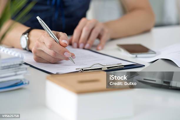 Woman Writing Something Sitting At Her Office Stock Photo - Download Image Now - Document, Women, Lawyer