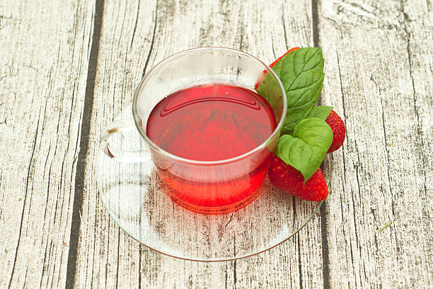 istock cup of tea with strawberries on wooden table 495627255