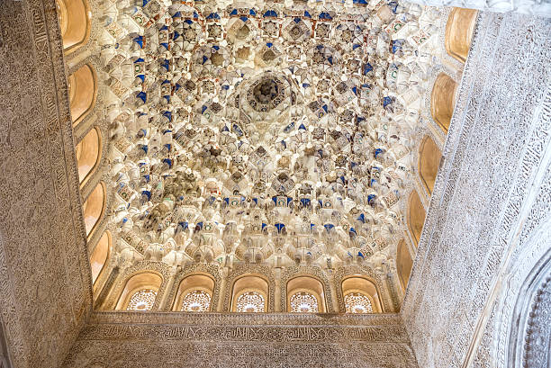 Granada, Spain  - Mai 28, 2015: Ceiling in Alhambra by night decorated with arabesques, calligraphy and muqarnas - a form of architectural ornamented vaulting, sometimes also called \