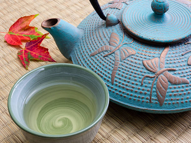 istock Oriental cast iron teapot with tea cup on tatami mat 495627596