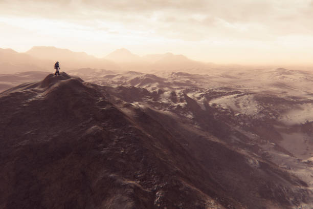 Astronaut walking on smaller Martian mountain ridge.