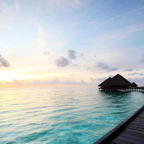 istock maldivian houses on sunrise 495628825
