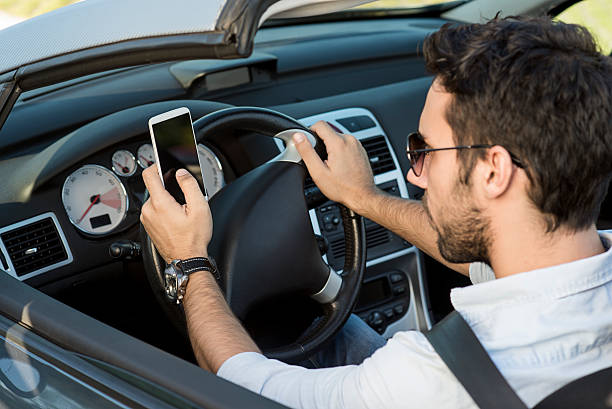 istock man typing text message on the phone in the car 495631609
