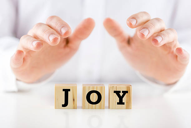 istock Mans hands cupped over the word Joy 495632043