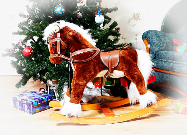 istock rocking horse with christmas tree 495633660