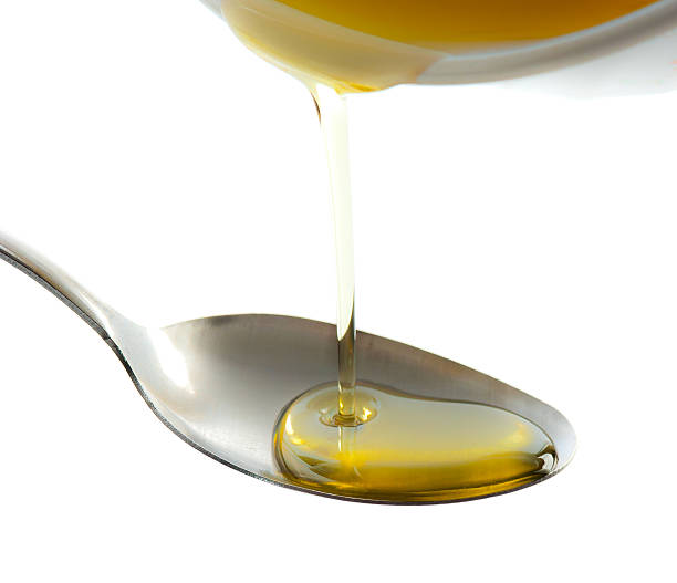 istock Pouring oil on spoon isolated on white 495635308